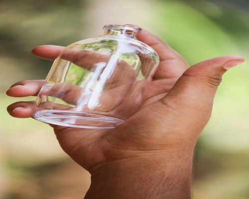 Close up of hands holding fresh water glass
